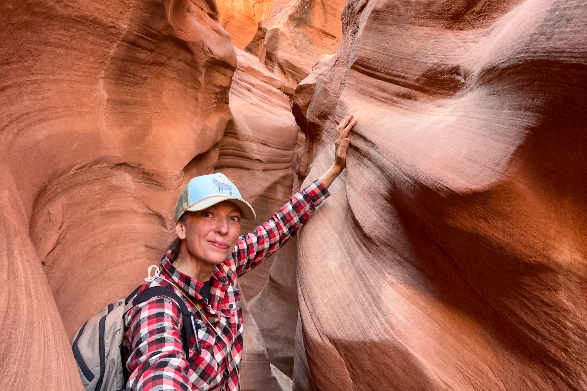 Peek-a-boo slot canyon with hiker