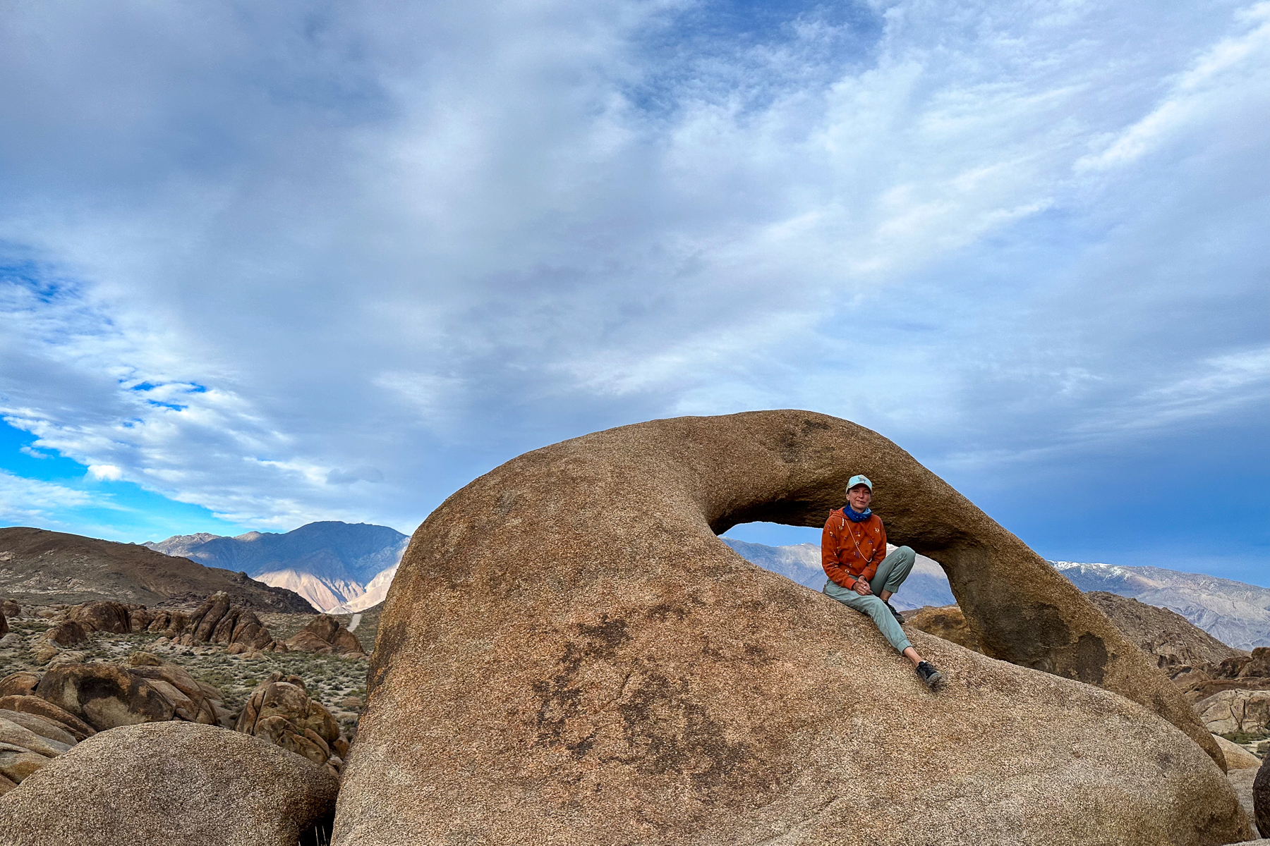 Hiker on the Mobius Arch trail, Alabama Hills